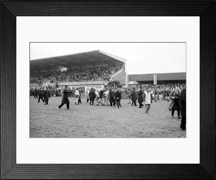 Framed Print : Hereford United fans celebrate by running on the pitch after second goal Hereford