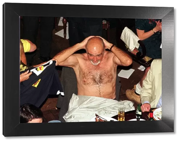 Sean Connery takes off his shirt June 1998 and puts on Scotland top given to him by his