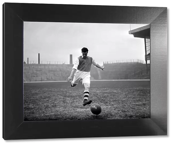 Leslie Compton kicks a football at Highbury Arsenal footballer circa 1935