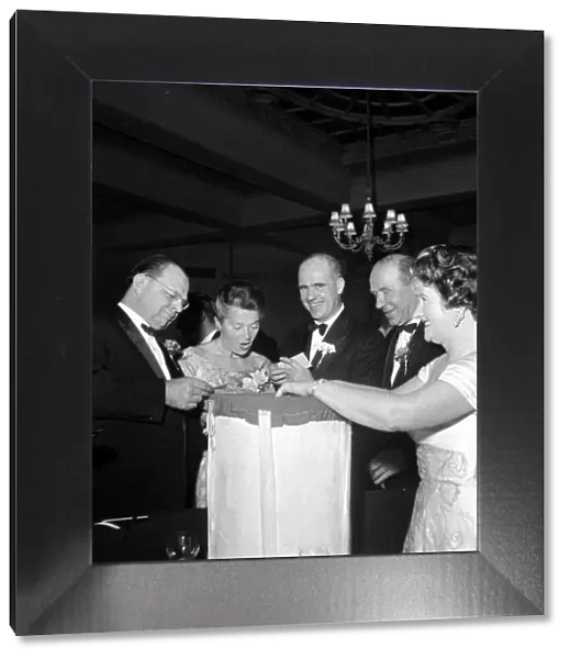 Matt Busby and his wife with Dr Maurer and wife pilling the winners of a lucky dip draw