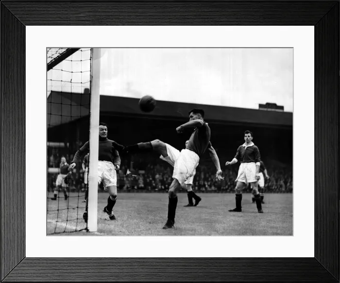 Framed Print : John Griffiths of Manchester United relieves pressure with an overhead clearance during Framed Print : John Griffiths of Manchester United relieves pressure with an overhead clearance during