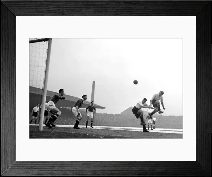 Framed Print : Manchester United versus Aston Villa Pace (left0 leaps higher than colleague Dixon Framed Print : Manchester United versus Aston Villa Pace (left0 leaps higher than colleague Dixon