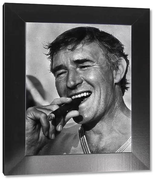 Football manager Malcolm Allison smoking a cigar. Circa 1975