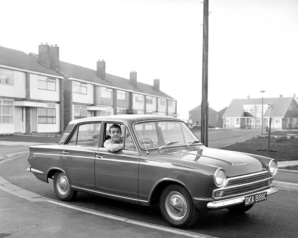 Liverpool footballer Ian St. John with his new Ford Cortina in Liverpool