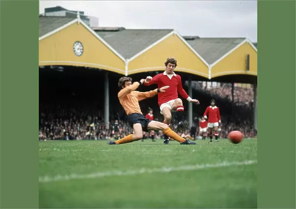 Brian Kidd of Manchester United takes on v J McAlle of Wolves