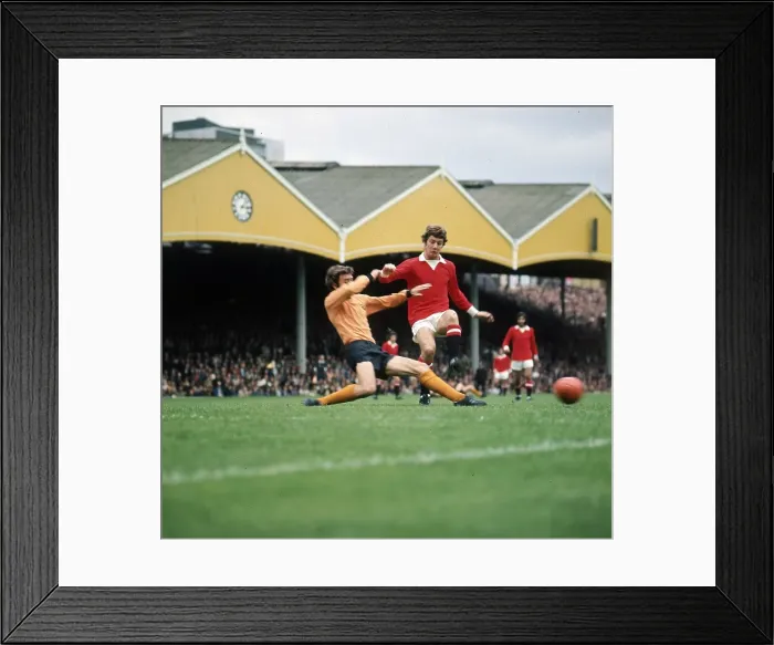 Framed Print : Brian Kidd of Manchester United takes on v J McAlle of Wolves