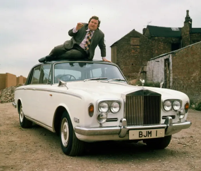 Framed Print : 00007433 Bernard Manning sitting on roof of Rolls Royce April 1981