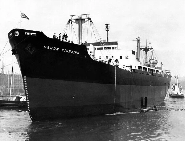The 11, 800-ton cargo ship Baron Kinnaird slides down the slipway at the shipyard of