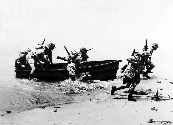 11th Battalion Royal Marines run ashore from a dingy while training in Ceylon