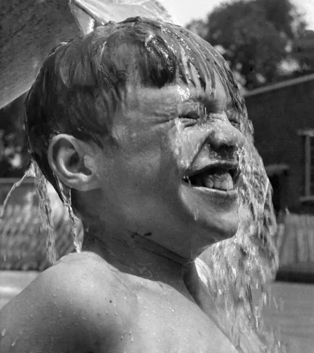 Framed Print : 13 years old David Ranswell of London enjoys every minute as his friends pour buckets of Framed Print : 13 years old David Ranswell of London enjoys every minute as his friends pour buckets of