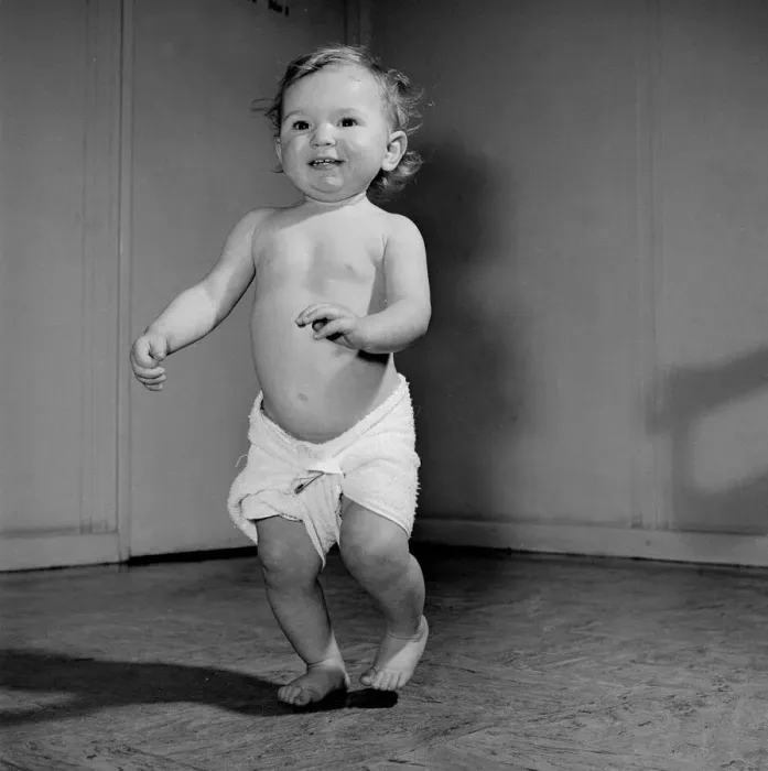 Framed Print : A 14 month baby toddles about the Baby Clinic before going in to the doctors surgery