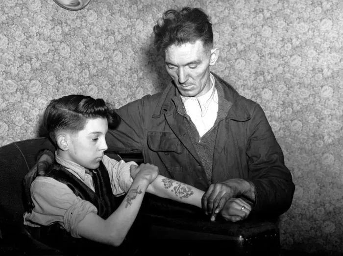 Framed Print : 14-year-old Arthur Waterworth of Droylsden shows off his tattooed forearms to his father