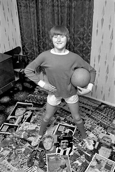 14-year-old Susan Lee surrounded by pictures of her favourite soccer stars wearing her