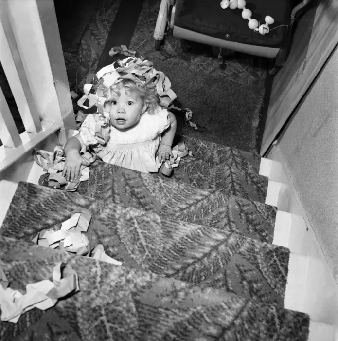 Framed Print : 15 month-old Janice Cook with Christmas chains climbing the stairs November 1953 Framed Print : 15 month-old Janice Cook with Christmas chains climbing the stairs November 1953
