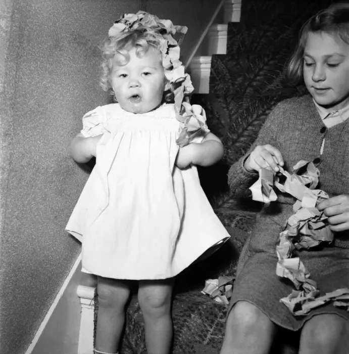 Framed Print : 15 month-old Janice Cook with Christmas chains playing in the living room November Framed Print : 15 month-old Janice Cook with Christmas chains playing in the living room November