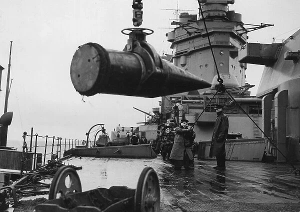 16'shells being lowered on to the deck of HMS Rodney from the ammunition ship
