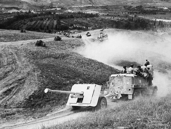 A 17pdr anti-tank gun and half-track of 269  /  87th Anti-Tank Regiment approaches the River