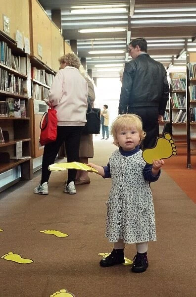 18-month-old Ellen Garbutt of Redcar sorts out the foot prints in Redcar Library