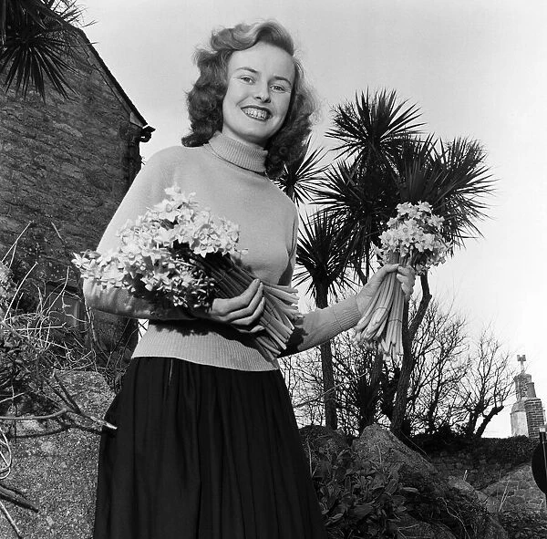 18-year-old Barbara Ball poses with some of the earliest Narcisi Soleil flowers ready for