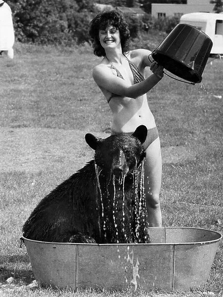 18 yr old Clair Kavan gives Daley the bear an ice cold bath to beat the heat wave