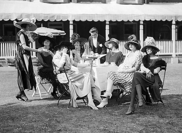 1921 Clothing Ascot Fashion Racegoers sit in a group at a table watching