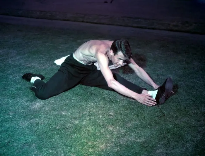 Framed Print : 1948 London Olympics in Colour. An athlete stretches