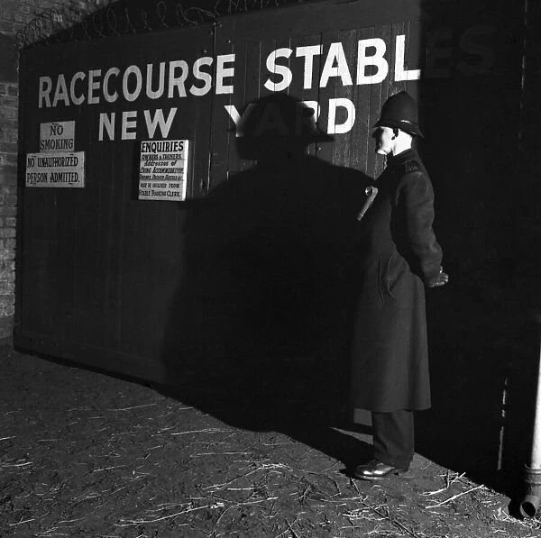 1952 Grand National. A policeman on guard outside new yard stables at Aintree