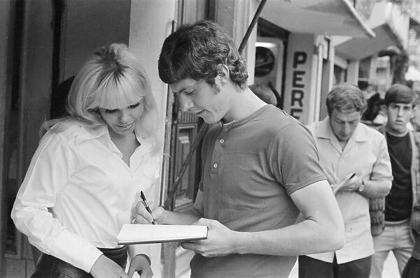 1970 World Cup Finals in Mexico. England footballer Brian Kidd signs an autograph