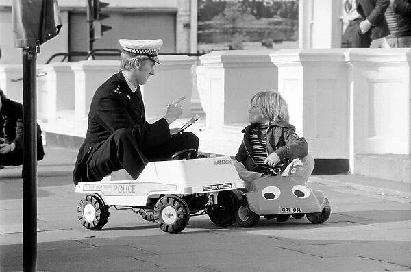 1975 Brighton Toy Fair. Police cut backs mean this traffic cop can only pull over