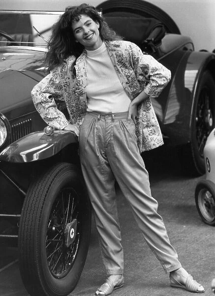 1980s Fashion: Model wears apple green trousers with green white pattern jacket standing