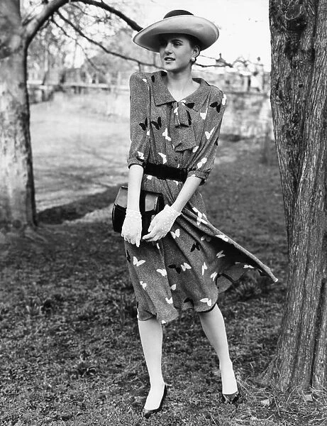 1980s Womens Fashion: Our model wears a butterfly motif belted dress
