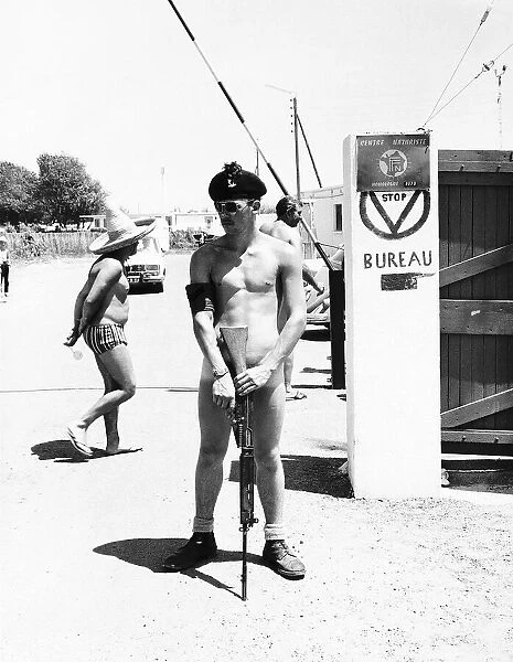 One of 1st Battalion Royal Irish Rangers on guard at the gates of the nudist camp next to