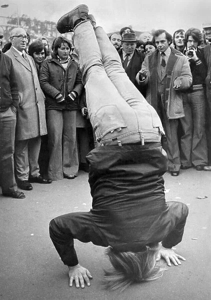 20 year old American student Tom Athmann stands on his head for the Speakers Corner