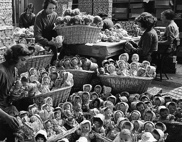 Some of the 2000 dolls that are produced each day in the dressng room. 25th July 1938