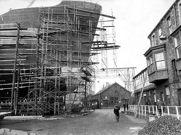 The 21, 000-ton ship Demerterton towers above the offices at the shipyard of John Redhead