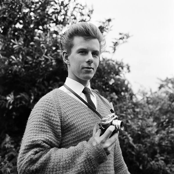 23 year old Gordon Faulkner in his garden, holding the camera with which he photographed