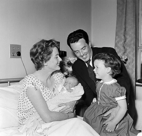 3-year-old Louisa, daughter of Brian Rix and Elspet Gray, meets her new baby brother