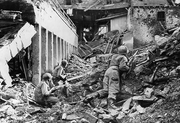 4th Division riflemen search for Nazi snipers after taking the German town of Prum