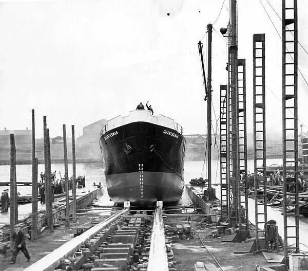 The 500 ton Quarterman tanker ship slips down the slipway at her launch