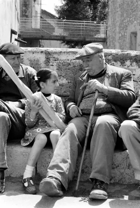 Framed Print : 6 year old Nathalie Rustan with her French loaves of bread talks to pensioner Michel