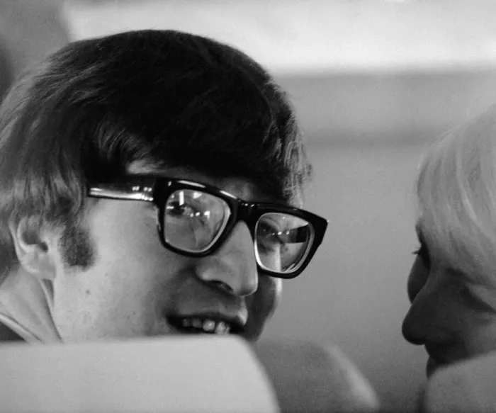 Framed Print : 7 February 1964 John Lennon with wife Cynthia on the aircraft to New York