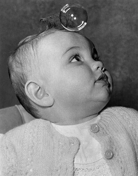 9 month old baby Janet Stringer playing with bubbles. Circa 1960 P012116