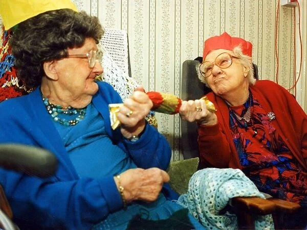 97 year olds Alison Lewis and Elizabeth Llewellyn pulling a cracker November