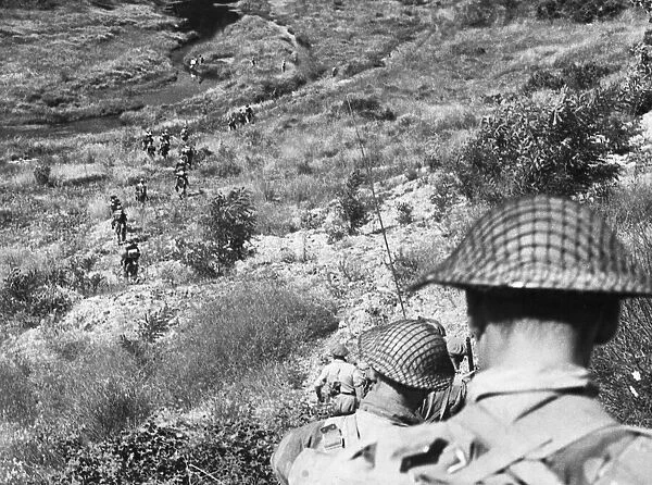 9th Army: Motorised Infantry Patrol in Italy. The men wind their way down into
