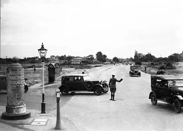 A a patrolman directs August Bank Holiday traffic outside The Orleans Arms situated