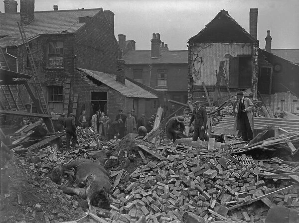 A. R. P workers clearing the debris from a wrecked Smethwick Stables where four horses
