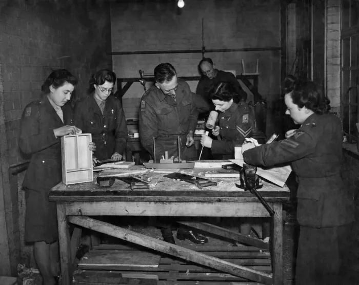 Framed Print : A. T. S. furniture factory. Lt. Archard (Centre) teaching his class the art of woodworking Framed Print : A. T. S. furniture factory. Lt. Archard (Centre) teaching his class the art of woodworking