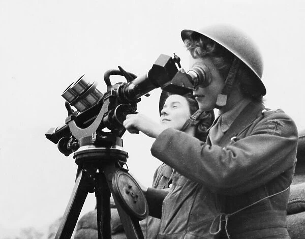A. T. S. girl uses an identification telescope. 22nd April 1941