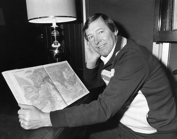Aberdeen manager Alex Ferguson looks at a map of Europe as he prepares to takes his side