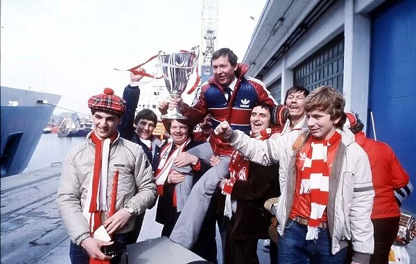 Aberdeen manager Alex Ferguson with members of his team hold the European Cup Winners Cup